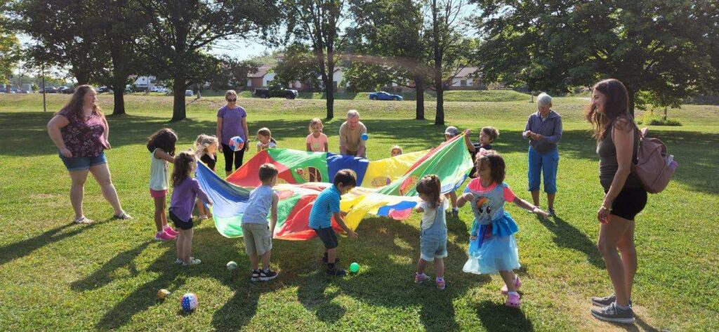 Children playing with parachite at Friday play for the Physical Health Group.